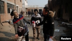 Actors rehearse their roles during the filming of the post-apocalyptic movie at an abandoned factory complex in Langfang, Hebei province, China, Dec. 16, 2016. Demand for video streaming of movies and TV shows has opened the door to new films and filmmake