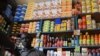 FILE - A shopkeeper receives payment in a roadside kiosk in Senegal's capital Dakar.
