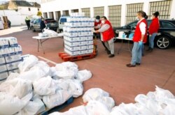 Members of the Spanish Red Cross prepare food for families in need at a food bank during the COVID-19 outbreak in Ronda, southern Spain, April 3, 2020.