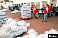 Members of the Spanish Red Cross prepare food for families in need at a food bank during the COVID-19 outbreak in Ronda, southern Spain, April 3, 2020.
