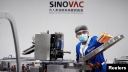 A man works in the packaging facility of Chinese vaccine maker Sinovac Biotech, developing an experimental coronavirus disease (COVID-19) vaccine, in Beijing, China, Sept. 24, 2020.