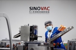 A man works in the packaging facility of Chinese vaccine maker Sinovac Biotech, developing an experimental coronavirus disease (COVID-19) vaccine, in Beijing, China, Sept. 24, 2020.