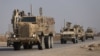 FILE - U.S. military vehicles drive in Hasaka, Syria, Dec. 6, 2024.