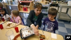 Teacher Diana Feke helps Mason Baker during lunch at the Eastham Community Center Claskamas County Children's Commission Head Start, April 9, 2012, in Oregon City.