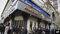 People stand in line to cast their votes at a mosque in eastern Tehran, Iran, during the parliamentary election, March 2, 2012.