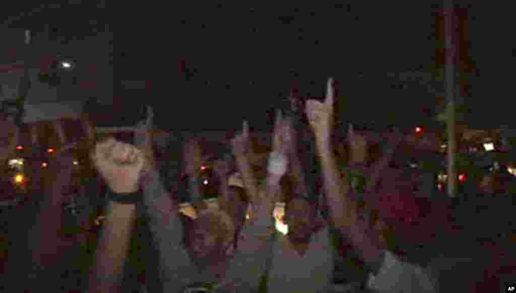 In this image from television, people celebrate in the streets of Tripoli, Libya, Aug. 21, 2011. (AP)