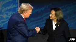 Republican presidential nominee Donald Trump shakes hands with Democratic presidential nominee Kamala Harris at the start of a debate in Philadelphia, Pennsylvania, on Sept. 10, 2024. Chinese and Russian media were largely subdued in their coverage of the debate.