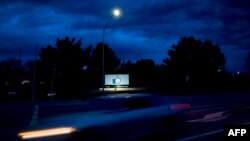 A car passes by Facebook's corporate headquarters location in Menlo Park, California, on March 21, 2018. 