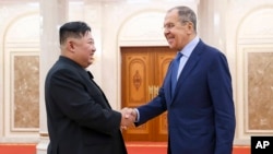 In this photo released by Russian Foreign Ministry Press Service via their telegram channel, Korean leader Kim Jong Un, left, and Russian Foreign Minister Sergey Lavrov greet each other during a meeting in Pyongyang, North Korea, on Oct. 19, 2023. 