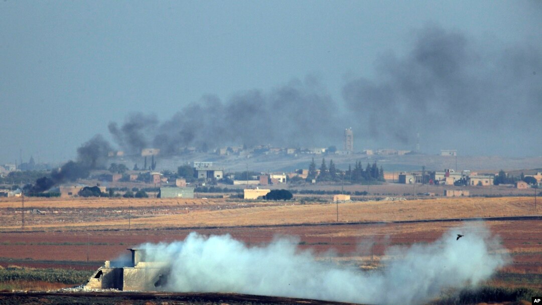 In this photo taken from the Turkish side of the border between Turkey and Syria, in Akcakale, Sanliurfa province, southeastern Turkey, smoke billows from targets inside Syria during bombardment by Turkish forces Wednesday, Oct. 9, 2019.