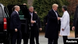 Le président américain Donald Trump serrant la main du Dr Ronny Jackson après son examen physique annuel au Centre médical militaire national Walter Reed à Bethesda, Maryland, États-Unis, le 12 janvier 2018. 