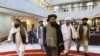 Taliban political deputy Mullah Abdul Ghani Baradar, center, arrives with other members of the Taliban delegation for an Afghan peace conference in Moscow, Russia, March 18, 2021.