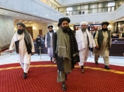 Taliban political deputy Mullah Abdul Ghani Baradar, center, arrives with other members of the Taliban delegation for an Afghan peace conference in Moscow, Russia, March 18, 2021.