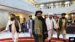 Taliban political deputy Mullah Abdul Ghani Baradar, center, arrives with other members of the Taliban delegation for an Afghan peace conference in Moscow, Russia, March 18, 2021.