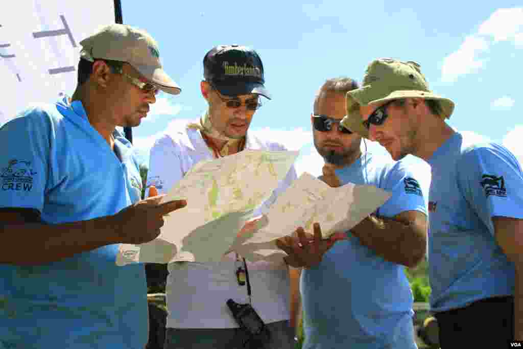 Members of Car 61 strategize at a checkpoint during Rhino Charge, in Narok county, Kenya, May 30, 2016. The evening before the competition, chargers are given GPS coordinates of 13 checkpoints to strategically map across an area of roughly 100 square kilometers of tough terrain. (J. Craig/VOA) &nbsp;