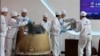 FILE - In this photo released by Xinhua News Agency, researchers prepare to weigh Chang'e 6 lunar samples at the China Academy of Space Technology under the China Aerospace Science and Technology Corporation, in Beijing on June 26, 2024. 