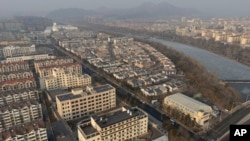 Residential complexes are seen near a frozen river in Miyun district in northeastern Beijing, on Feb. 27, 2025.