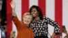 Democratic presidential candidate Hillary Clinton, accompanied by first lady Michelle Obama, greet supporters during a campaign rally in Winston-Salem, N.C., Oct. 27, 2016. Researcher Susan Madsen says there are striking similarities among powerful women across the globe.