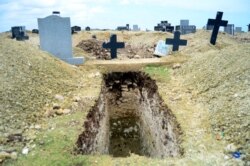 FILE - A freshly-dug grave sits at the Motherwell Cemetery in Port Elizabeth, South Africa, Dec. 4, 2020.
