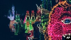 FILE -The Main Street Electrical Parade moves down Main Street in Disneyland, in Anaheim, Calif., during its last night of performances, Nov. 25, 1996. 