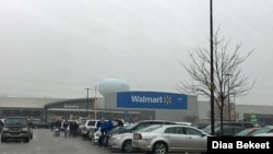 FILE - Shoppers walk in the parking lot of a Walmart store in Fairfax, Virginia. (Photo: Diaa Bekheet) 