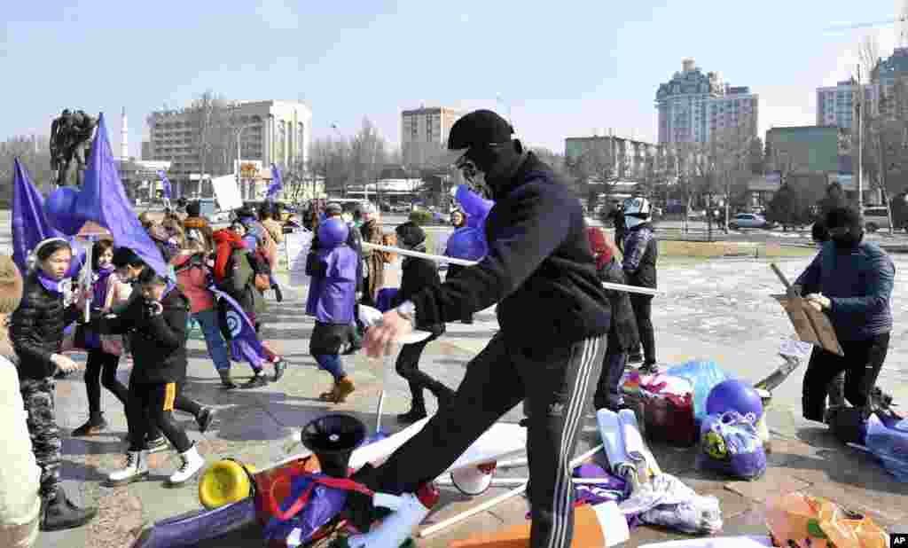 Masked Kyrgyz nationalists attack women&#39;s rights activists during the celebration of the International Women&#39;s Day at Victory Square in Bishkek, Kyrgyzstan.