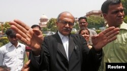 FILE - Prominent lawyer Prashant Bhushan, seen in this 2018 file photo, shared a tweet showing a photo of Chief Justice Sharad Arvind Bobde on an expensive Harley Davidson motorcycle without a face mask even though people were around him.