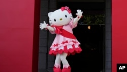 Hello Kitty waves as she appears to attend the opening ceremony of the exhibition "As I change, so does she," marking the 50th anniversary of Hello Kitty at the Tokyo National Museum in Tokyo, Oct. 30, 2024.