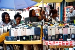 Women vendors display Nokia phone models for sale along with smartphones at the 'Computer Village' in Ikeja district in Nigeria's commercial capital Lagos, Nigeria, May 31, 2017.