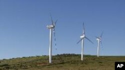 Giant wind turbines dot the landscape at the Darling Wind Power national demonstration project near Cape Town. 