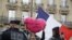 A "Yellow vest" protester holds a heart-shaped sign reading "French President Emmanuel Macron I hate you with all my heart" in front of the Galeries Lafayette department store during an anti-government "yellow vests" protest in Paris, Sept. 28, 2019.
