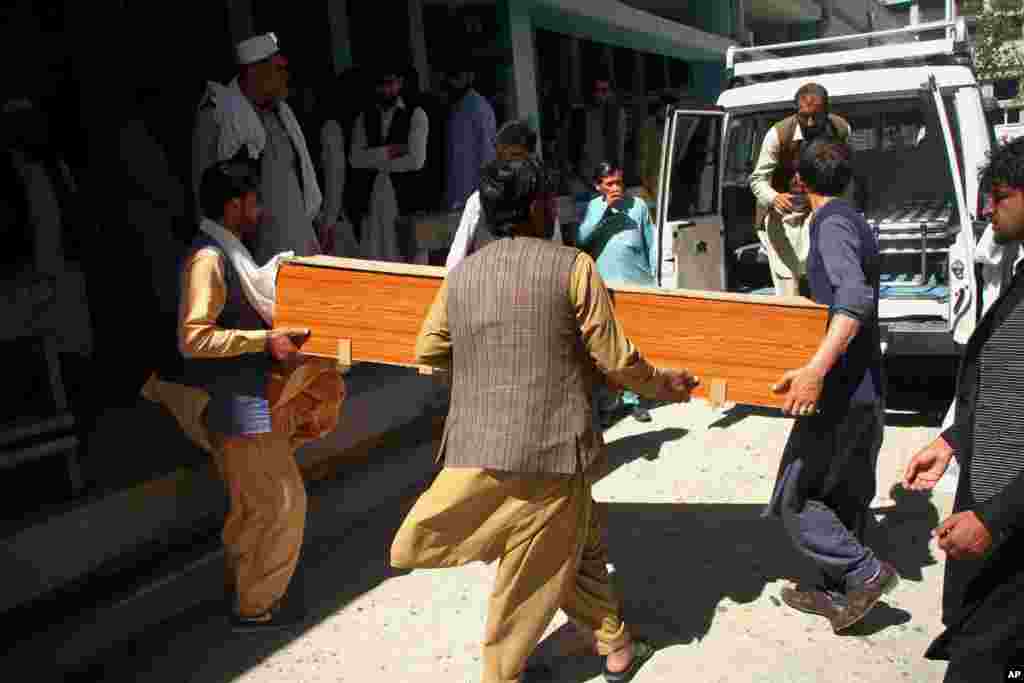 Afghans carry a coffin of the body of a woman who was killed by gunmen in the city of Jalalabad, east of Kabul.&#160;Attackers gunned down three women working to administer the anti-polio vaccine in eastern Afghanistan, officials said.