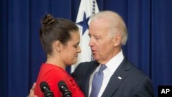 FILE - Vice President Joe Biden consoles Madeleine Smith after she recounted her story of being a rape victim while a student at Harvard University.