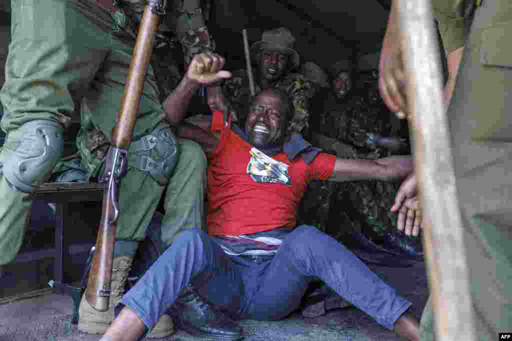 Kenyan police officers arrest an activist during a demonstration to demand the release of government critics who&#39;s abductions are unexplained in Nairobi.