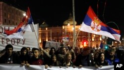 People march during a protest in Belgrade, Serbia, March 16, 2019. Thousands of people rallied in Serbia's capital for 15th week in a row against populist President Aleksandar Vucic and his government.