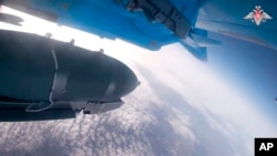 In this photo taken from video released by the Russian Defense Ministry on Nov. 28, 2024, an Su-34 bomber of the Russian air force drops bombs on Ukrainian positions at an undisclosed location.