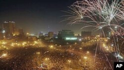 Fireworks explode as tens of thousands of Egyptians celebrate the fall of the regime of former President Hosni Mubarak, and to maintain pressure on the current military rulers, in Tahrir Square in downtown Cairo, Egypt, February 18, 2011.