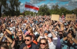 Belarusians attend a meeting in support of Svetlana Tikhanovskaya, candidate for the presidential elections, in Hlybokaje, Belarus, July 24, 2020.