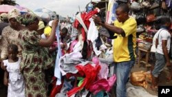 In this photo taken June 18, 2012, people buy secondhand clothes at Katangua market in Lagos, Nigeria. 