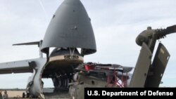 Tentara Amerika bersiap memindahkan helikopter Blackhawk ke Galaxy Super C-5M, 11 September 2017. Helikopter tersebut merupakan satu dari 35 pesawat yang direlokasi untuk mendukung usaha bantuan bagi para korban Badai Irma. (Foto: dok).