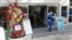 Health care workers work at a walk-up COVID-19 testing site during the coronavirus pandemic, July 17, 2020, in Miami Beach, Fla. 