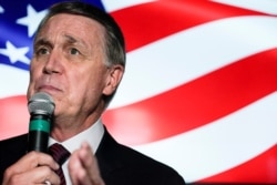 FILE - Candidate for U.S. Senate Sen. David Perdue speaks during a campaign rally, in Cumming, Ga., Nov. 13, 2020.