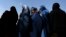 Afghan women line up to receive aid from the Afghan government in Kabul on August 1, 2013. 