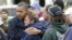 President Barack Obama, left, embraces Donna Vanzant, right, during a tour of a neighborhood effected by superstorm Sandy, Oct. 31, 2012 in Brigantine, N.J.
