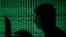FILE PHOTO: Man holds laptop computer as cyber code is projected on him in this illustration picture