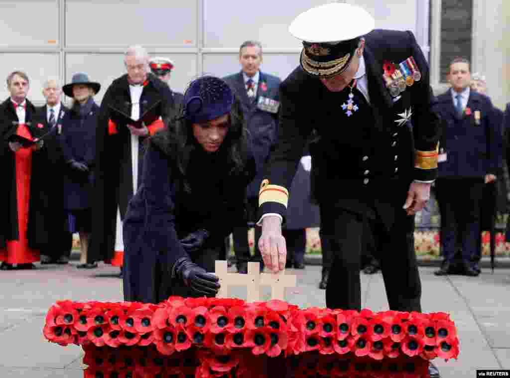 Britain’s Meghan, Duchess of Sussex, places a cross during the 91st Field of Remembrance at Westminster Abbey in London.