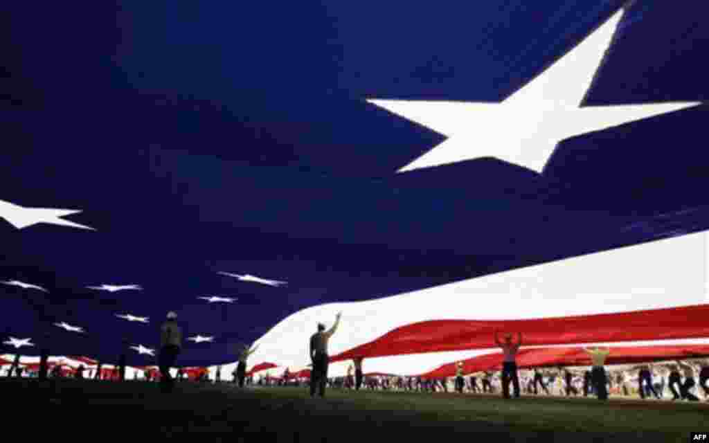 United States Marines hold up a giant flag before the Holiday Bowl NCAA college football game between California and Texas, Wednesday, Dec. 28, 2011, in San Diego. (AP Photo/Gregory Bull)