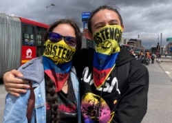 Protesters Michelle Calderón and Diego Parra take part in anti-government protests in Bogota, Colombia, July 20, 2021. (Megan Janetsky/VOA)