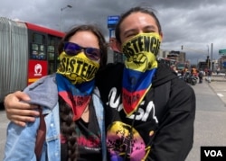Protesters Michelle Calderón and Diego Parra take part in anti-government protests in Bogota, Colombia, July 20, 2021. (Megan Janetsky/VOA)