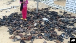 FILE - Discarded shoes of victims remain outside al-Rawdah mosque in Bir al-Abed, northern Sinai, Egypt, a day after attackers killed hundreds of worshippers, Nov. 25, 2017.